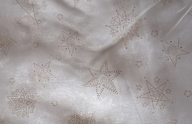 Organza creme mit goldenen Sternen bedruckt 
